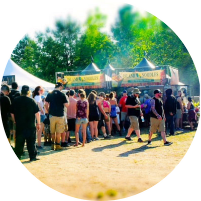 a crowd lined up at a food stand